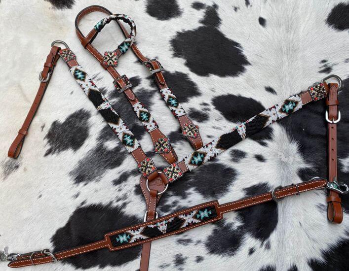 Showman 4 Piece Steer Head Beaded One Ear Headstall and Breast Collar Set - front view on far printed background