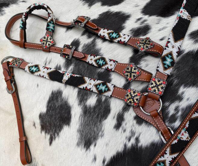 Showman 4 Piece Steer Head Beaded One Ear Headstall and Breast Collar Set - side view on close printed background